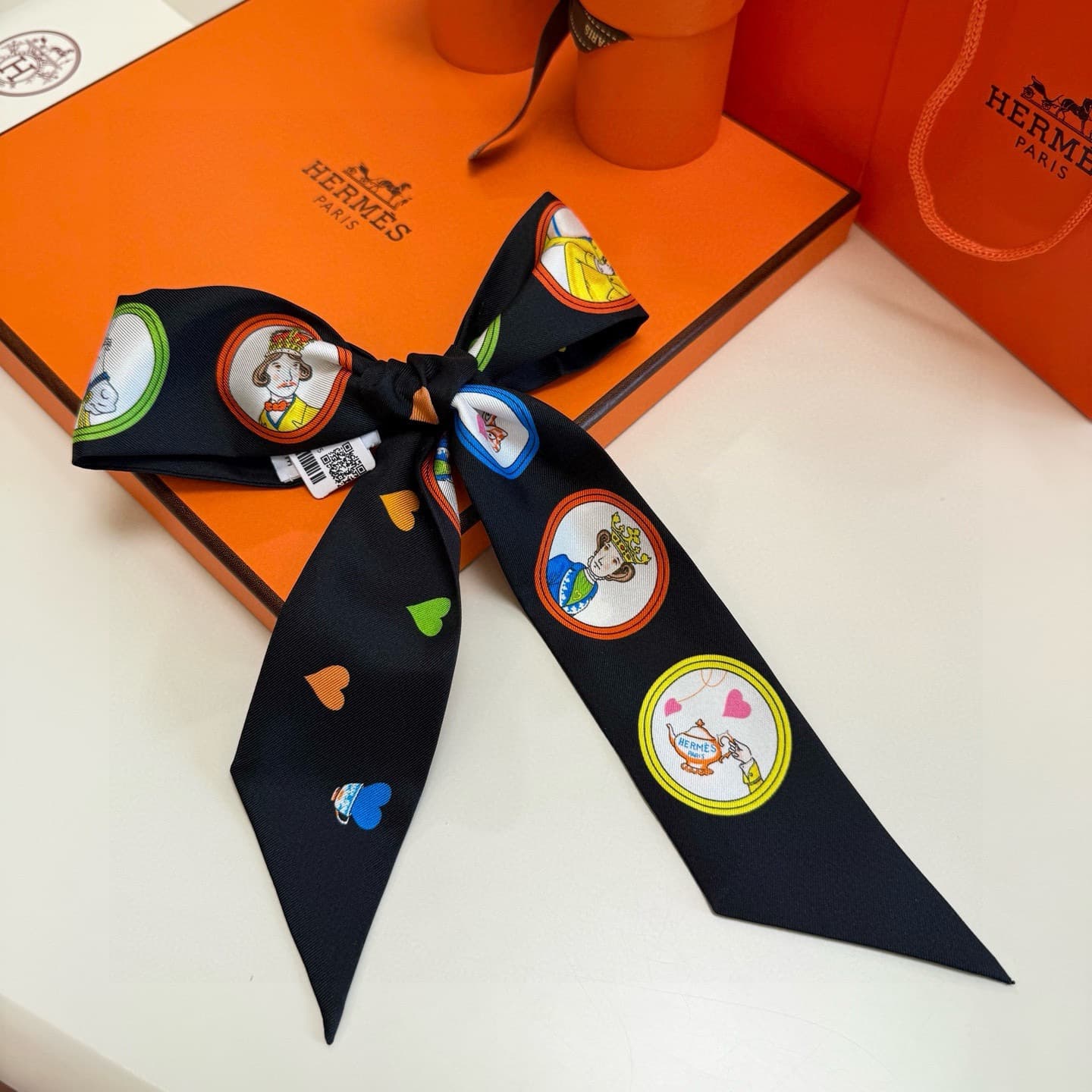 Hermes Twilly scarf featuring the 'Tea Time' motif