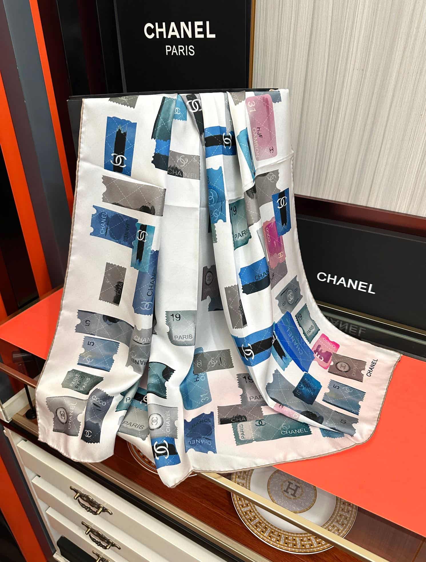 Chanel silk scarf featuring blue and pink stamp print