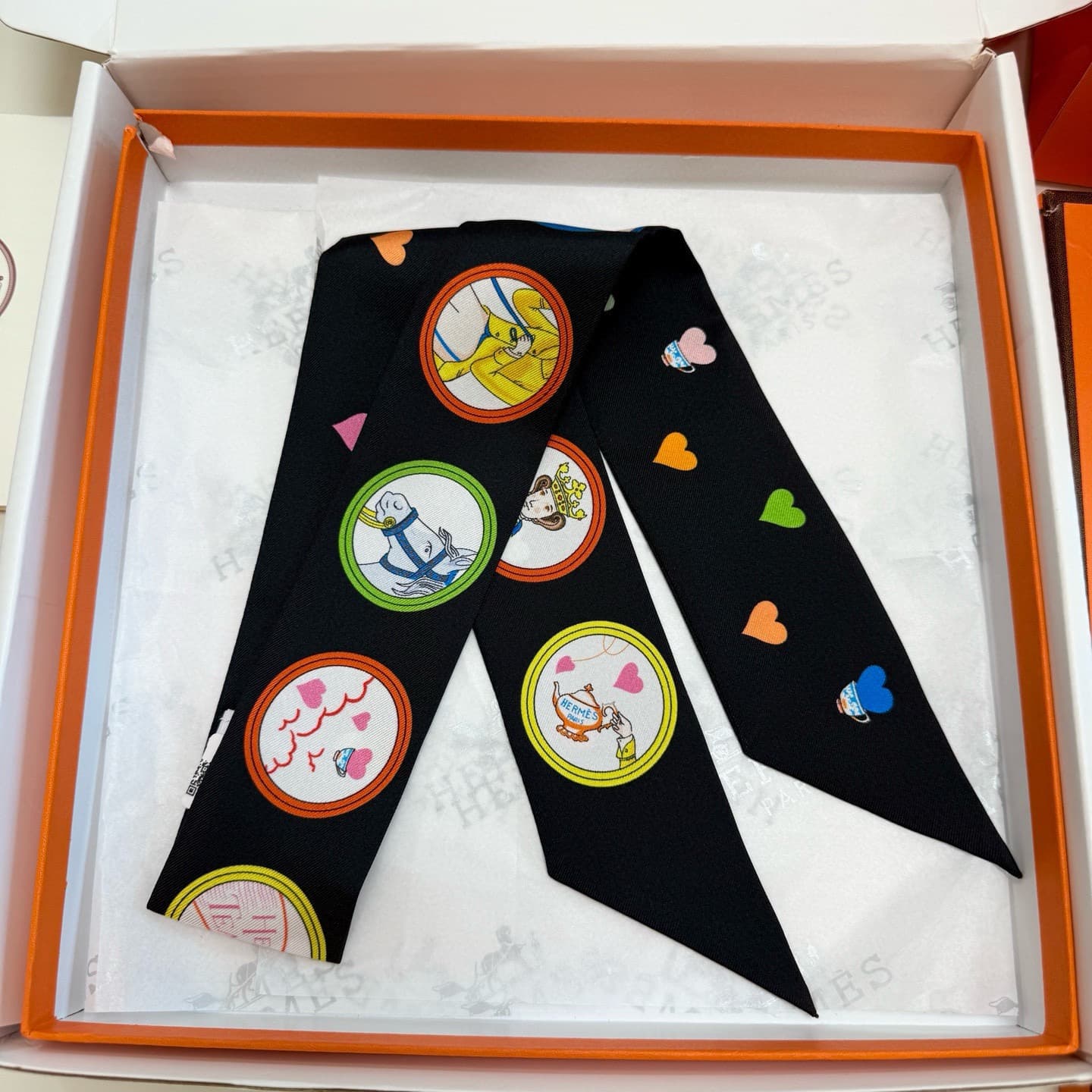 Hermes Twilly scarf featuring the 'Tea Time' motif