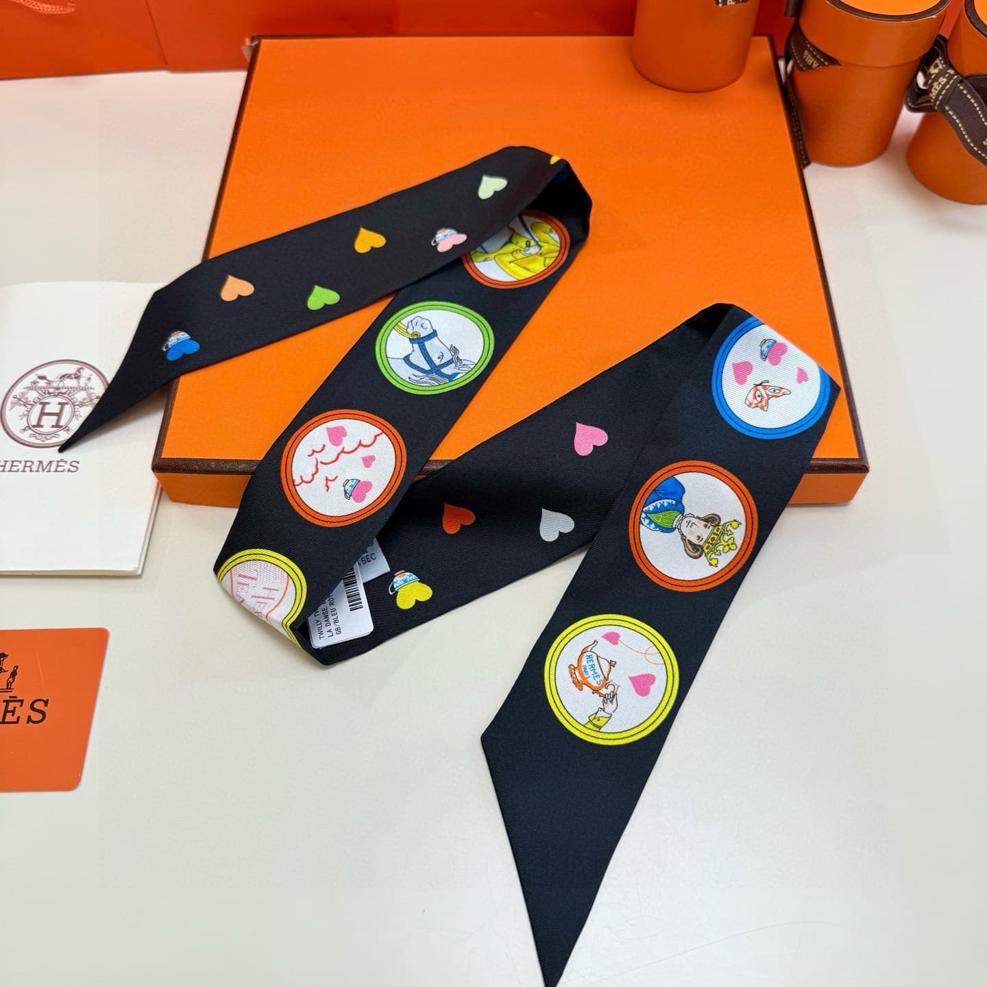 Hermes Twilly scarf featuring the 'Tea Time' motif