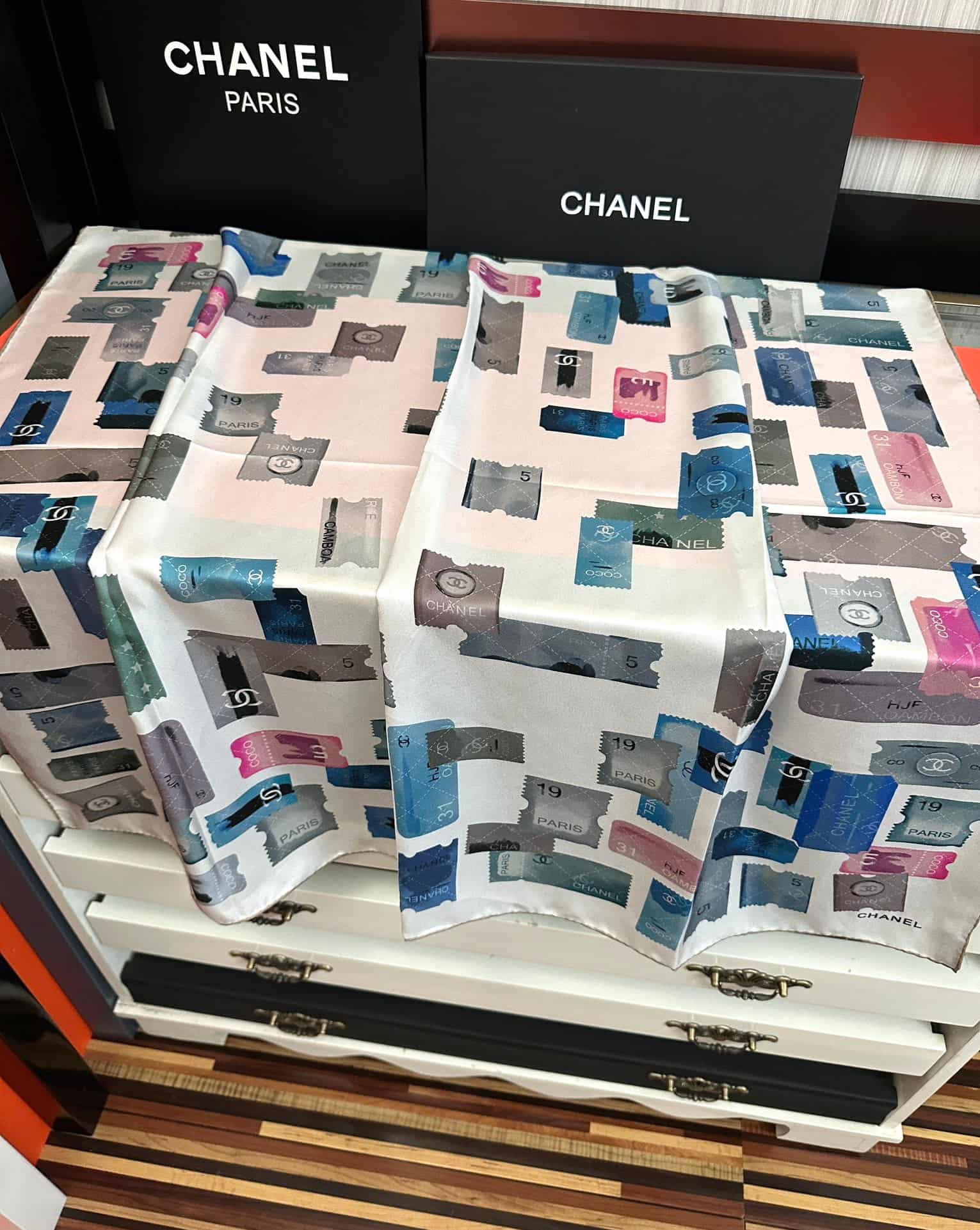 Chanel silk scarf featuring blue and pink stamp print