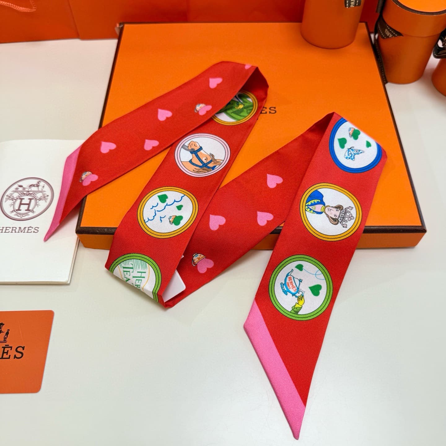 Hermes Twilly scarf featuring the 'Tea Time' motif