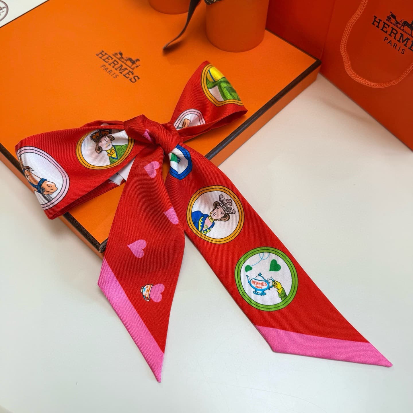 Hermes Twilly scarf featuring the 'Tea Time' motif
