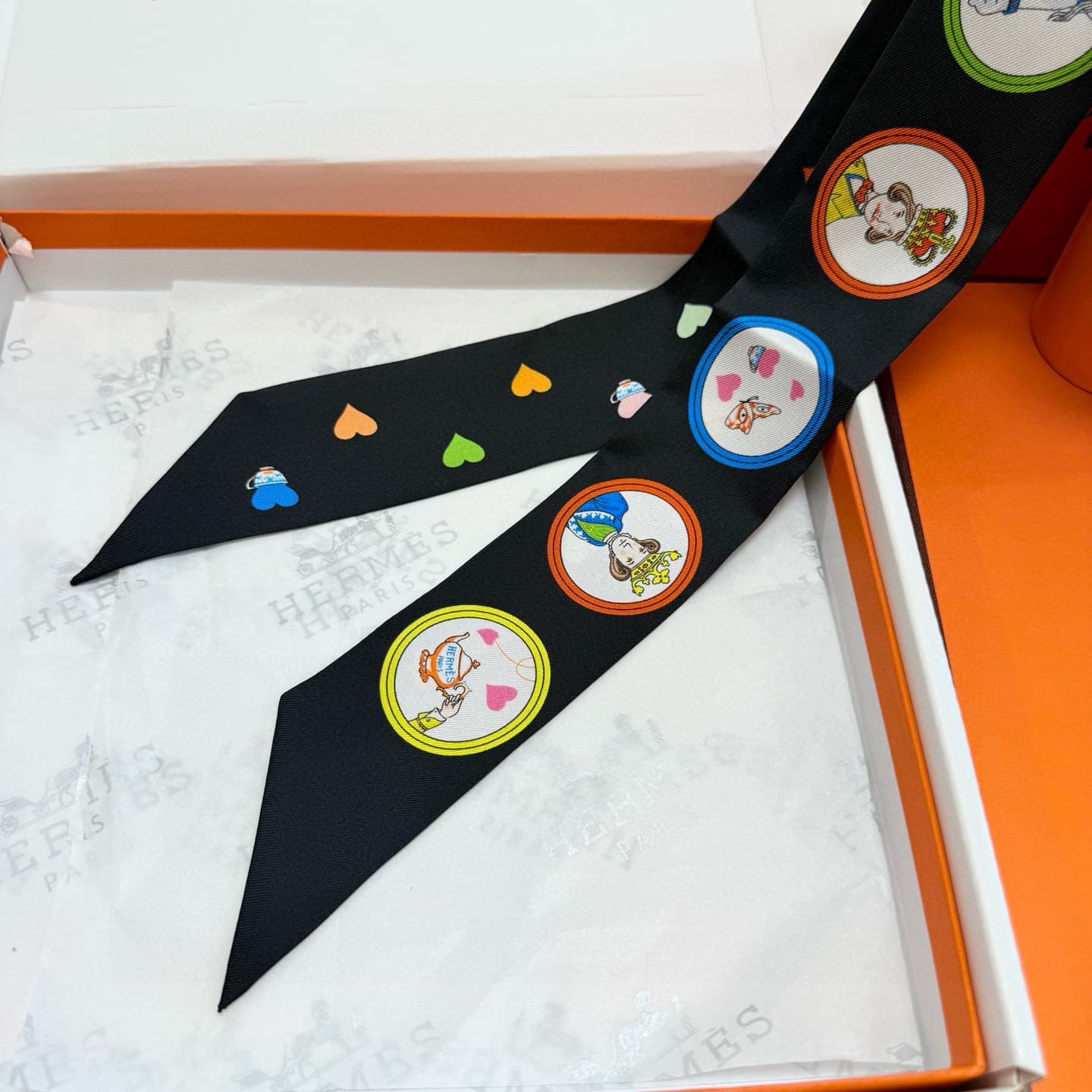 Hermes Twilly scarf featuring the 'Tea Time' motif