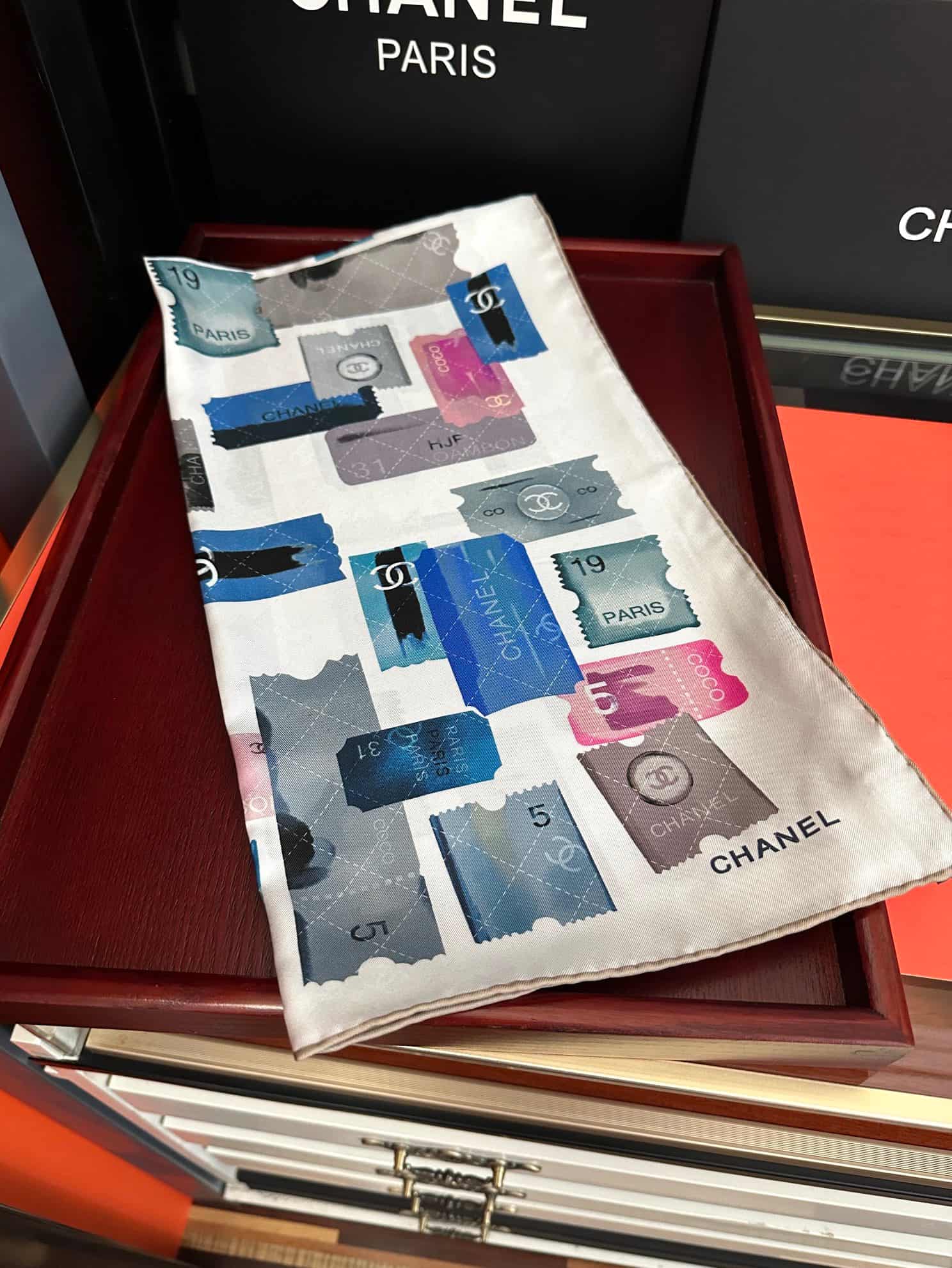 Chanel silk scarf featuring blue and pink stamp print